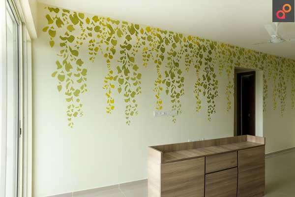 Floral and leafy wall design in a green room - Aapka Painter Blogs
